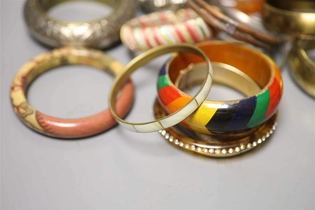 A collection of bangles, including five ethnic white metal examples,